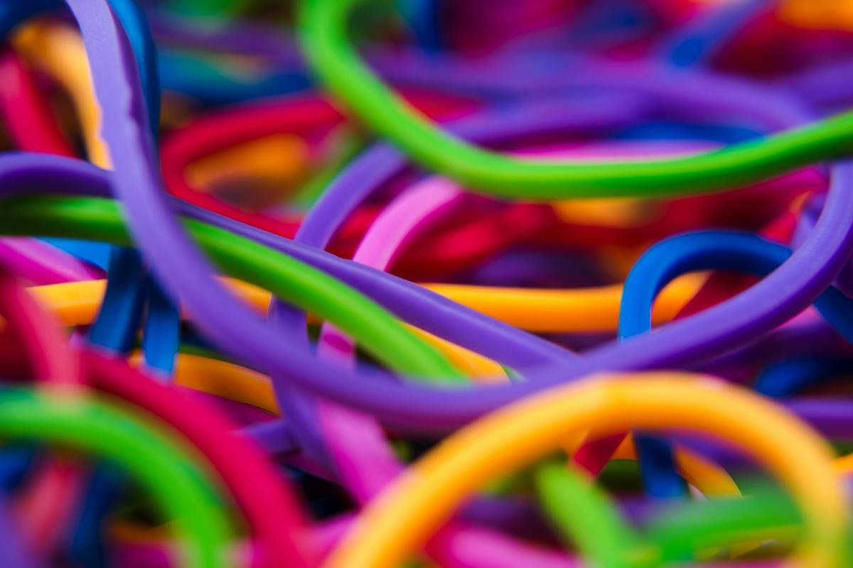 Side-by-side comparison: hair strand under microscope showing smooth cuticle with scrunchie vs. fractured cuticle with standard elastic