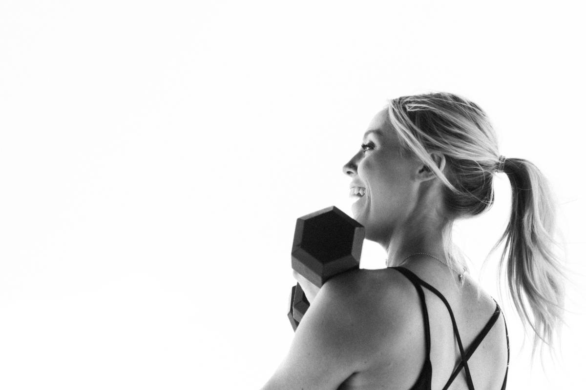 Female athlete using sports hair wraps during intense workout session